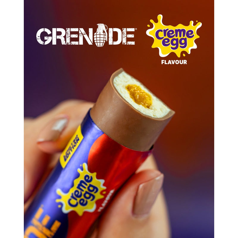 Creme Egg Grenade chocolate bar held by a hand with Grenade packaging.